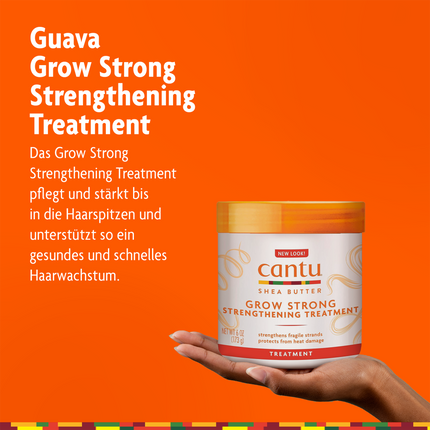 Cantu Grow Strong Strengthening Treatment - 173g auf Hand und Schrift auf orangefarbenen Grund