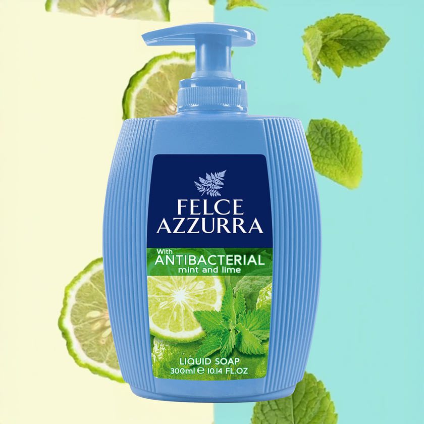 Felce Azzurra Flüssigseife Antibacterial Mint&Lime auf zweifarbigen Hintergrund mit Minzblättern und Limettenscheiben