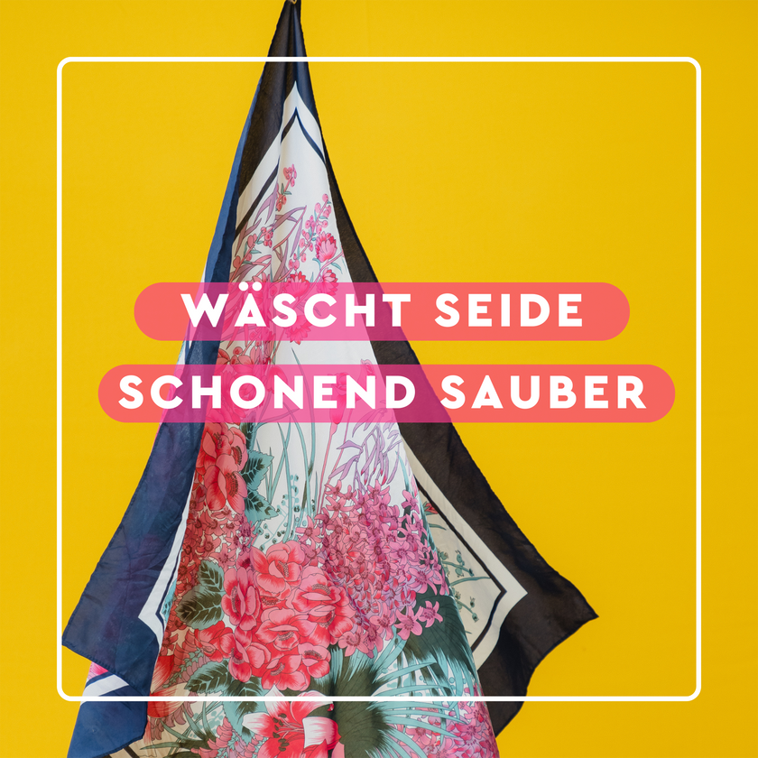 Seidentuch auf gelbem Grund und Schrift auf pinken Balken