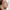Frau mit Gua Sha Stein an der Wange und YEAUTY Eye Pad Mask Extreme Energy unter den Augen